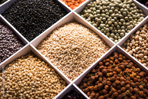 Indian Beans,Pulses,Lentils,Rice and Wheat grain in a white wooden box with cells, selective focus.