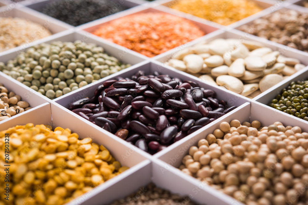 Indian Beans,Pulses,Lentils,Rice and Wheat grain in a white wooden box with cells, selective focus. Indian Beans,Pulses,Lentils,Rice and Wheat grain in a white wooden box with cells, selective focus.