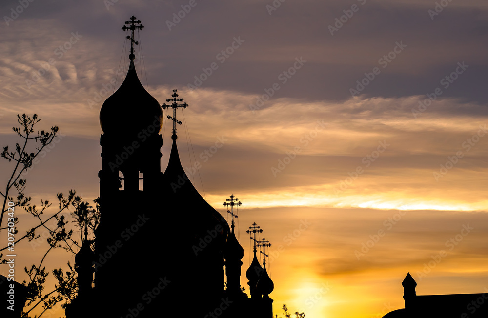 the silhouette of the Church with domes in the early morning at dawn