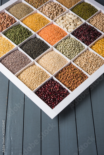 Indian Beans,Pulses,Lentils,Rice and Wheat grain in a white wooden box with cells, selective focus.