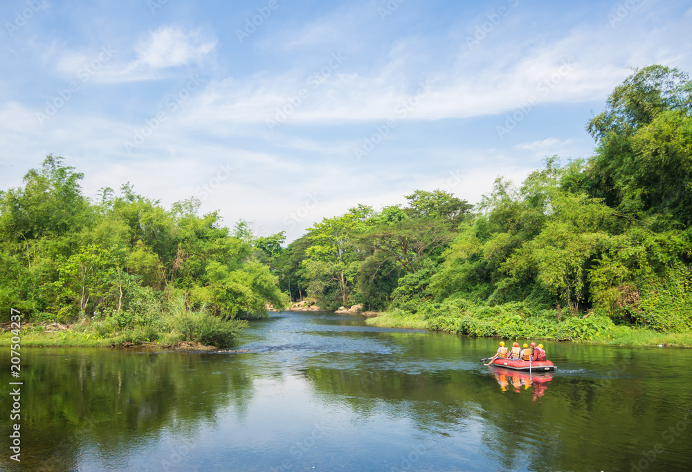 Fototapeta premium A group of men and women are rafting on the river, extreme and fun sport