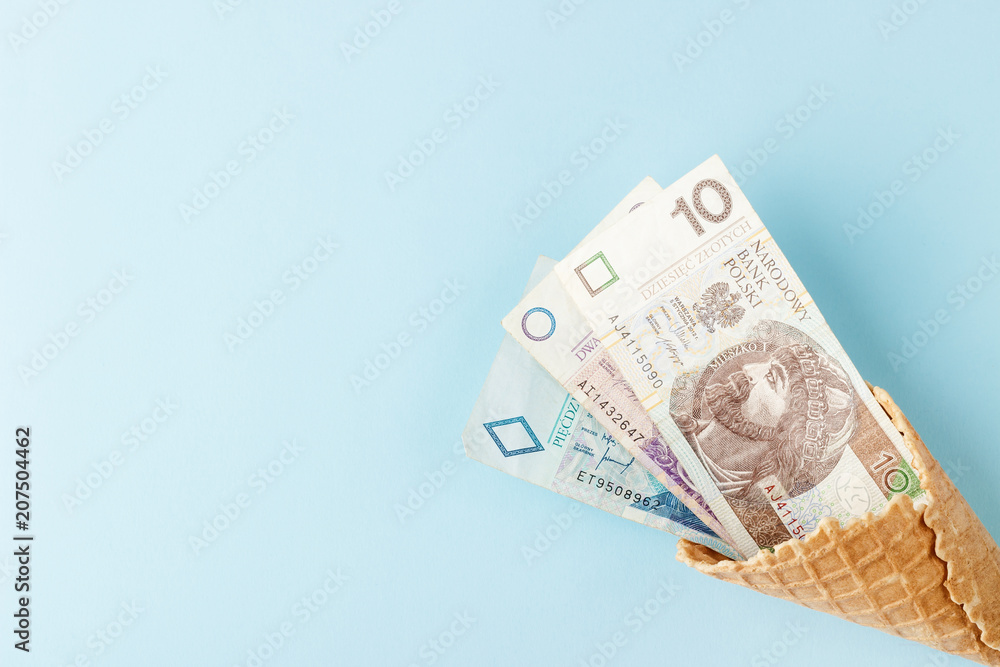 Polish zloty on a blue paper background Polish zloty on a blue paper background