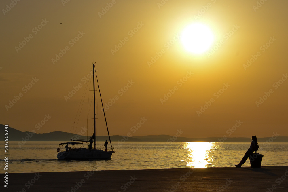 Zadar sunset with silhouette of boat on the sea, Croatia