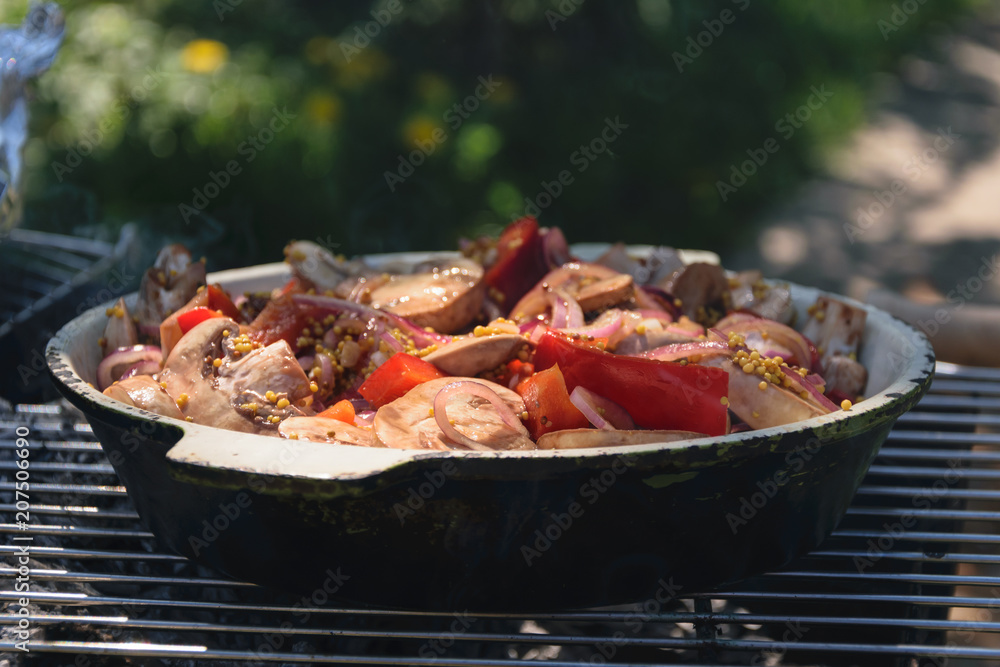 vegetables cooked in a frying pan on a fire outside vegetables cooked in a frying pan on a fire outside