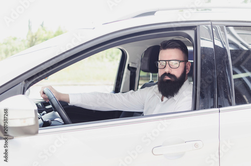businessman with a beard in a expensive car, busy