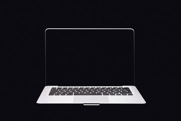 Portable modern silver computer on a black background.