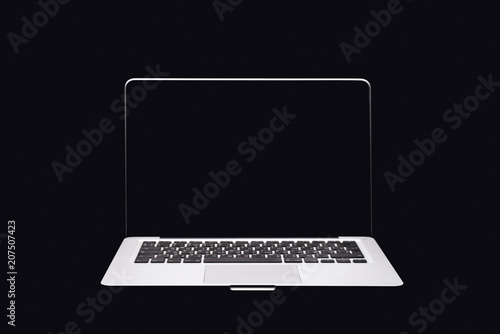 Portable modern silver computer on a black background.