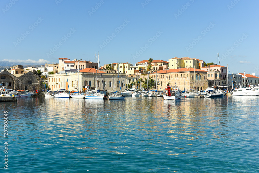 View of the Venetian port of Chania with the center of mediterranean architecture, ships and pleasure boats