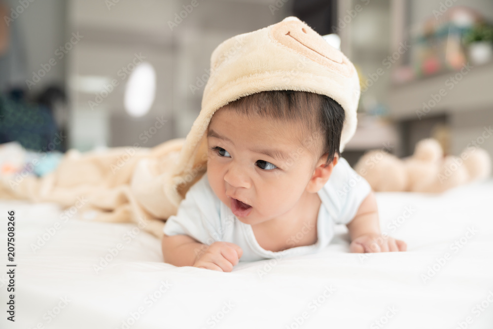 Portrait of a crawling baby on the bed in her room, Adorable baby boy in white sunny bedroom, Newborn child relaxing in bed, Nursery for young children, Textile and bedding for kids Portrait of a crawling baby on the bed in her room, Adorable baby boy in white sunny bedroom, Newborn child relaxing in bed, Nursery for young children, Textile and bedding for kids