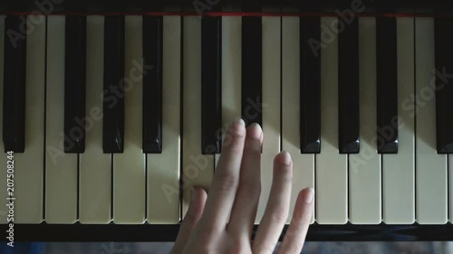 A girl practicing on the piano. photo