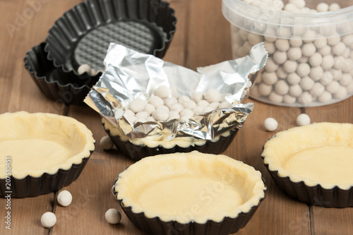 Cooking Process Of Tartlets. Ceramic Baking Beans. Tins.