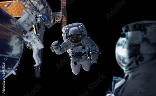 Fototapeta Naklejka Na Ścianę i Meble -  Astronaut working on a space station 3D rendering elements of this image furnished by NASA