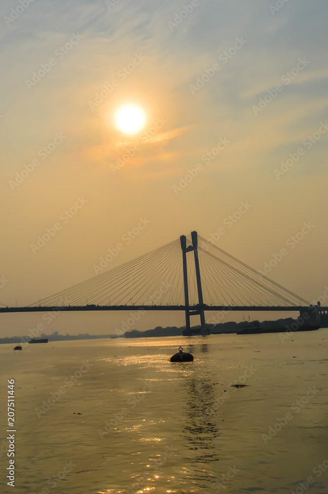 View of second Hooghly Bridge Kolkata India taken at dusk, at dawn, at daytime in landscape style. The Subject of the image is, inspiration, exciting, hopeful, bright, sensational, tranquil, calm