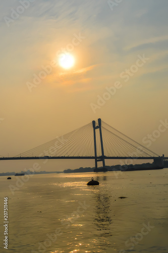 View of second Hooghly Bridge Kolkata India taken at dusk, at dawn, at daytime in landscape style. The Subject of the image is, inspiration, exciting, hopeful, bright, sensational, tranquil, calm © SB Stock