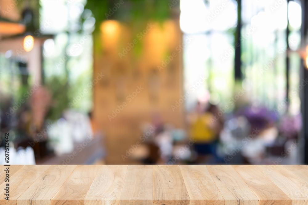 Empty wooden table and blurred cafe background, can be used for display or montage your products Empty wooden table and blurred cafe background, can be used for display or montage your products