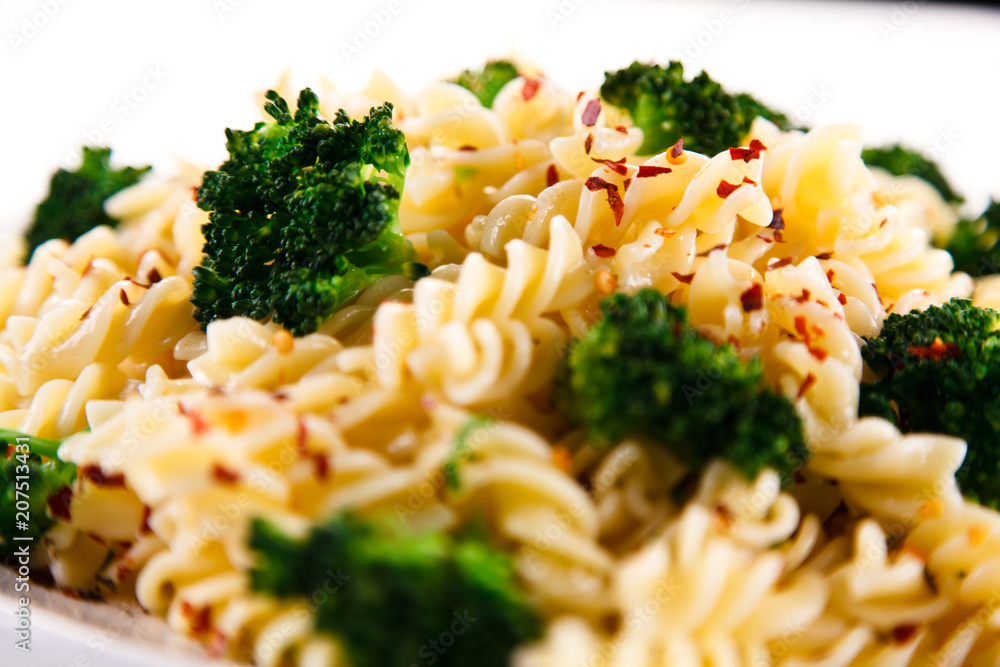 Pasta with herbs and broccoli on white background Pasta with herbs and broccoli on white background