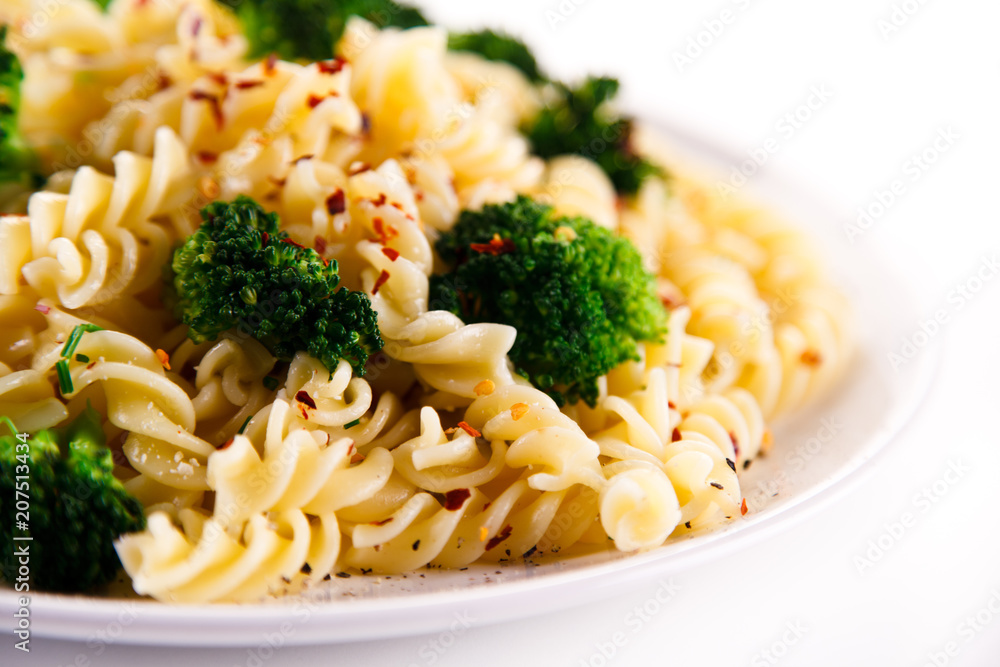 Pasta with herbs and broccoli on white background Pasta with herbs and broccoli on white background