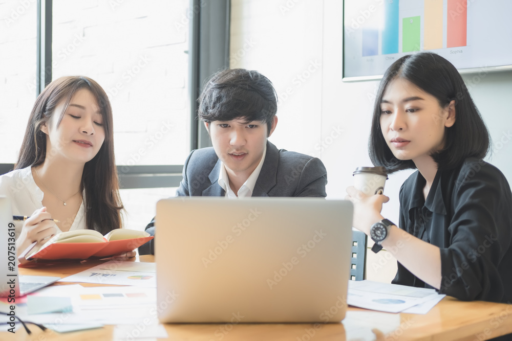 Asian business people meeting with new startup project pointing graph discussion and analysis data charts and graphs.Business finances and accounting concept Asian business people meeting with new startup project pointing graph discussion and analysis data charts and graphs.Business finances and accounting concept