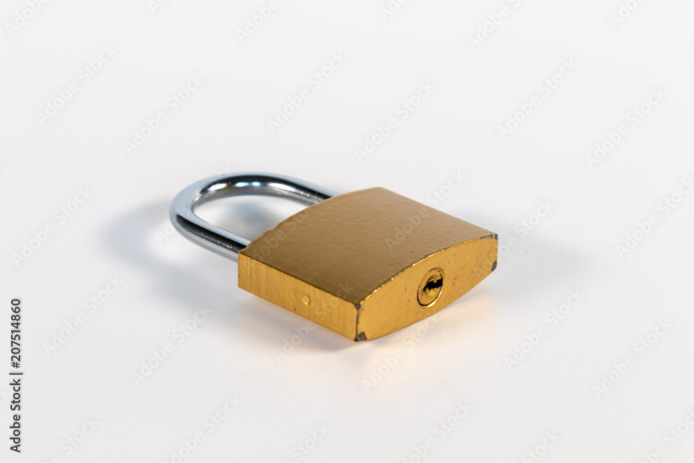 Closed golden padlock in front of white background Closed golden padlock in front of white background
