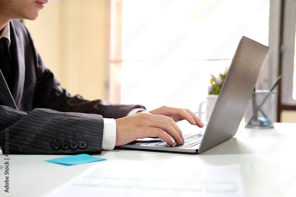 Businessman working with computer laptop with lighting morning and side view photo. Businessman working with computer laptop with lighting morning and side view photo.