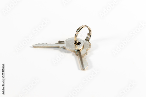 Wad of keys with two small keys isolated on white background