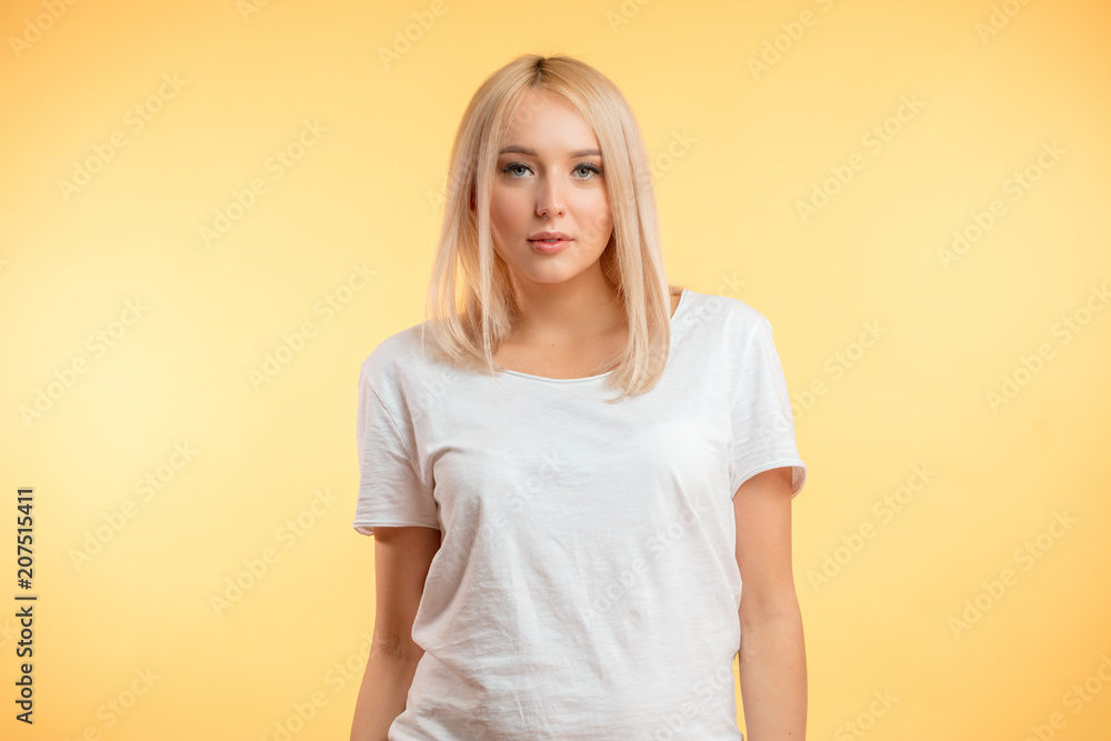 closeup photo of nice blond girl wearing white T-shirt isolated on the yelloe background. skin beauty closeup photo of nice blond girl wearing white T-shirt isolated on the yelloe background. skin beauty