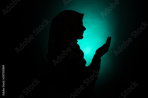 silhouette of muslim woman praying