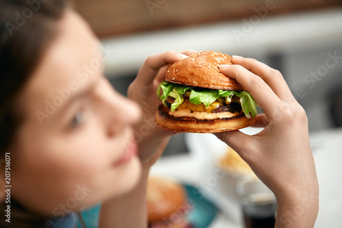 Eating Burger. Woman Holding Hamburger In Hands