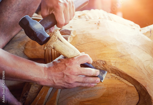 Fotografija Closeup Old man Hands of craftsman wooden carve with a gouge in the hands on the