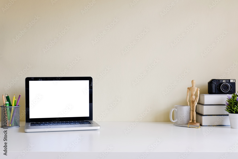Mockup blank screen computer laptop on desk. Workspace with laptop and office supplies.