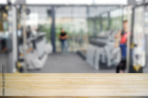 Wood table is empty in fitness gym. © Prathankarnpap