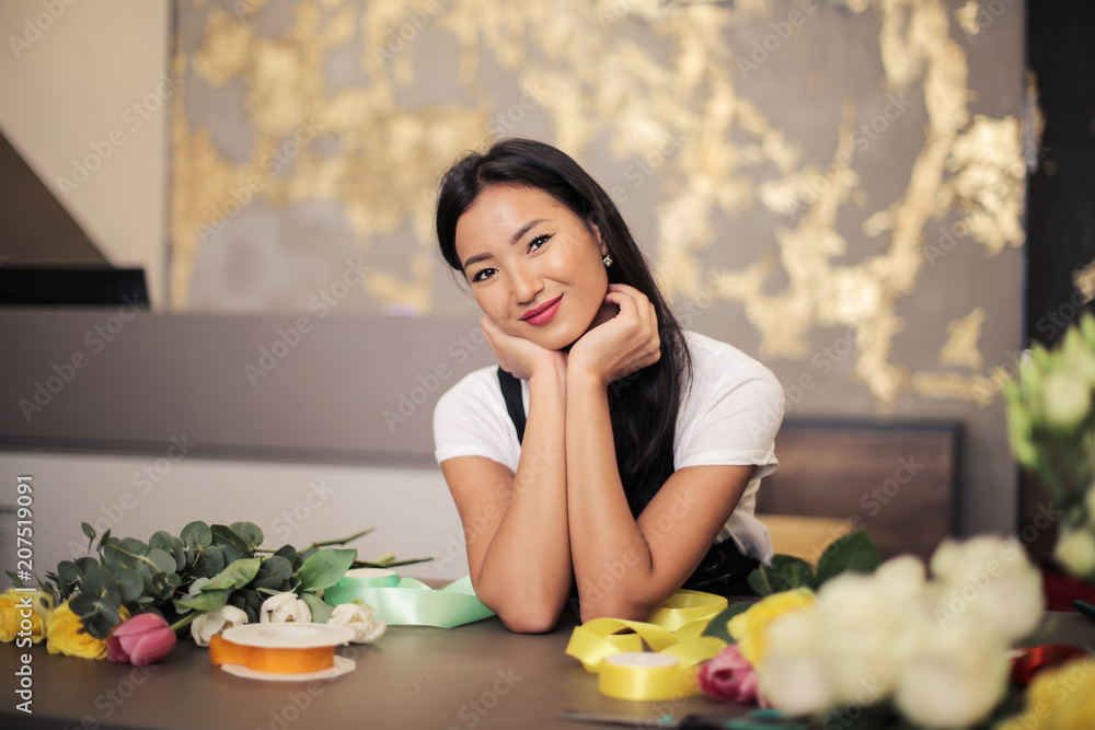 Cheerful florist at the counter Cheerful florist at the counter
