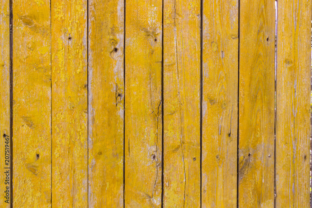 wooden fence painted yellow, close-up, horisontal. wooden fence painted yellow, close-up, horisontal.