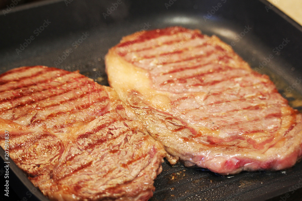 Two steaks cooked on the pan Two steaks cooked on the pan
