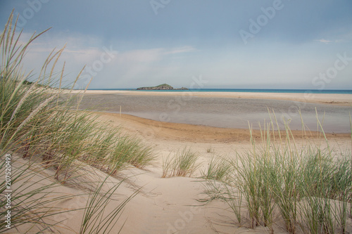 A beautiful landscape of a desert beach in south Sardinia, Italy. Marine panorama in a spring day before the summer tourists arrive. Blue sky with clouds in background. A view of a coast with wild nat