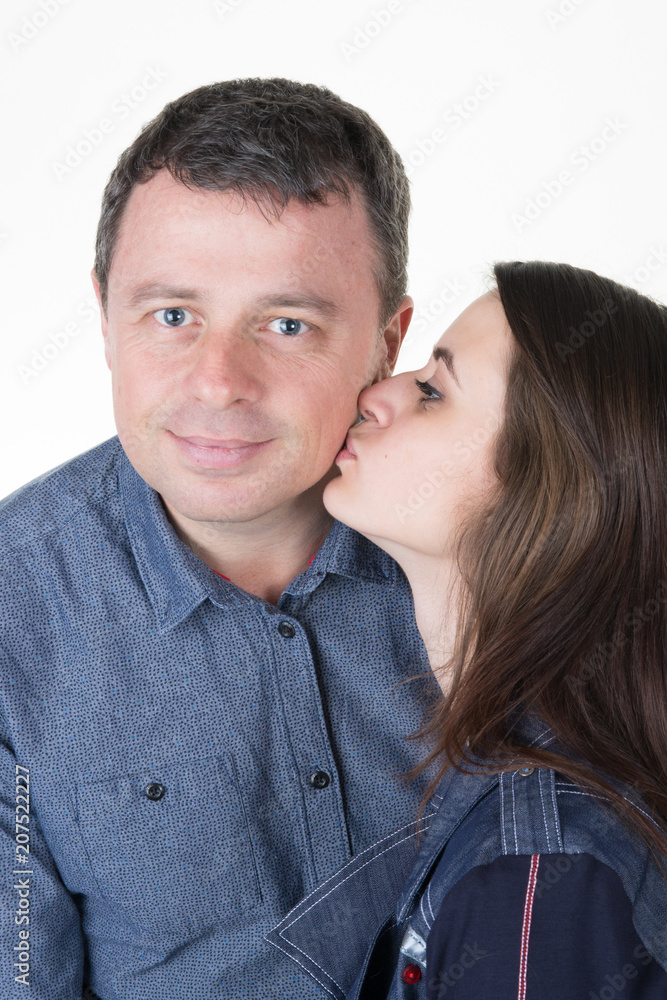 Portrait of father and girl daughter kiss with tenderness