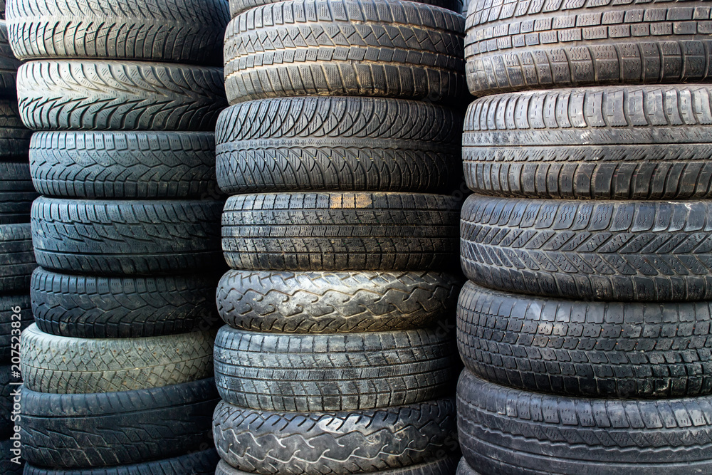 Pile of used car tires. Background with stacks of tires for recycling. Pile of used car tires. Background with stacks of tires for recycling.