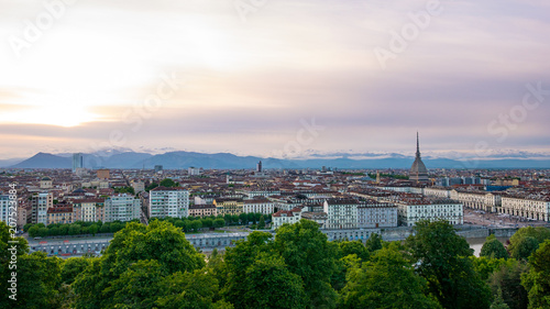 Turin skyline at sunset. Torino, Italy, panorama cityscape with the Mole Antonelliana over the city. Scenic colorful light and dramatic sky.