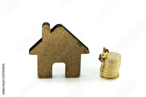 Miniature people : Couple of love with dollar sign,piggy bank,house, Saving to buy a house or home savings concept.