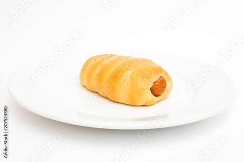 sausage bread roll on white plate