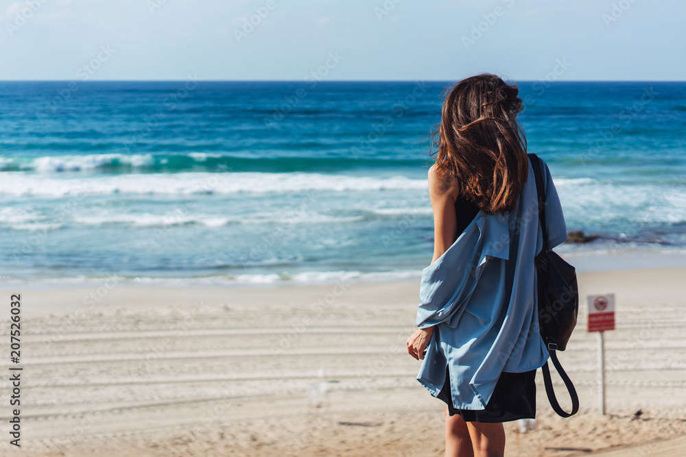 Young beautiful girl looks afar at sea Young beautiful girl looks afar at sea