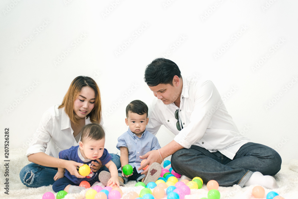 Happy Asian Family - Father and Mother Playing with 2 Son in Living Room on Vacation , Lifestyle Concept Happy Asian Family - Father and Mother Playing with 2 Son in Living Room on Vacation , Lifestyle Concept