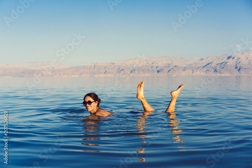 Girl is relaxing and swimming in the water