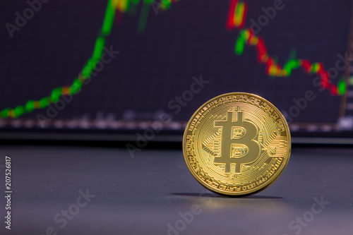 Golden bitcoin and stock chart on tablets. Bokeh concept.