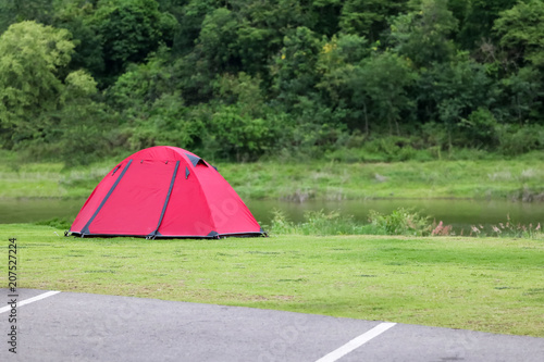 Campsite and tents on the lawn with beautiful green nature landscapes of forests