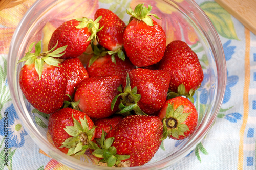 Fresh strawberry in a transparent salad bowl