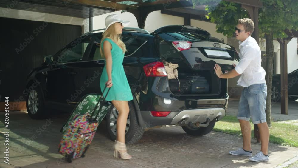 SLOW MOTION, LENS FLARE: Excited young couple bickers overpacking too much baggage for their summer holiday. Caucasian husband gets frustrated with his wife packing too many bags for their honeymoon. SLOW MOTION, LENS FLARE: Excited young couple bickers overpacking too much baggage for their summer holiday. Caucasian husband gets frustrated with his wife packing too many bags for their honeymoon.