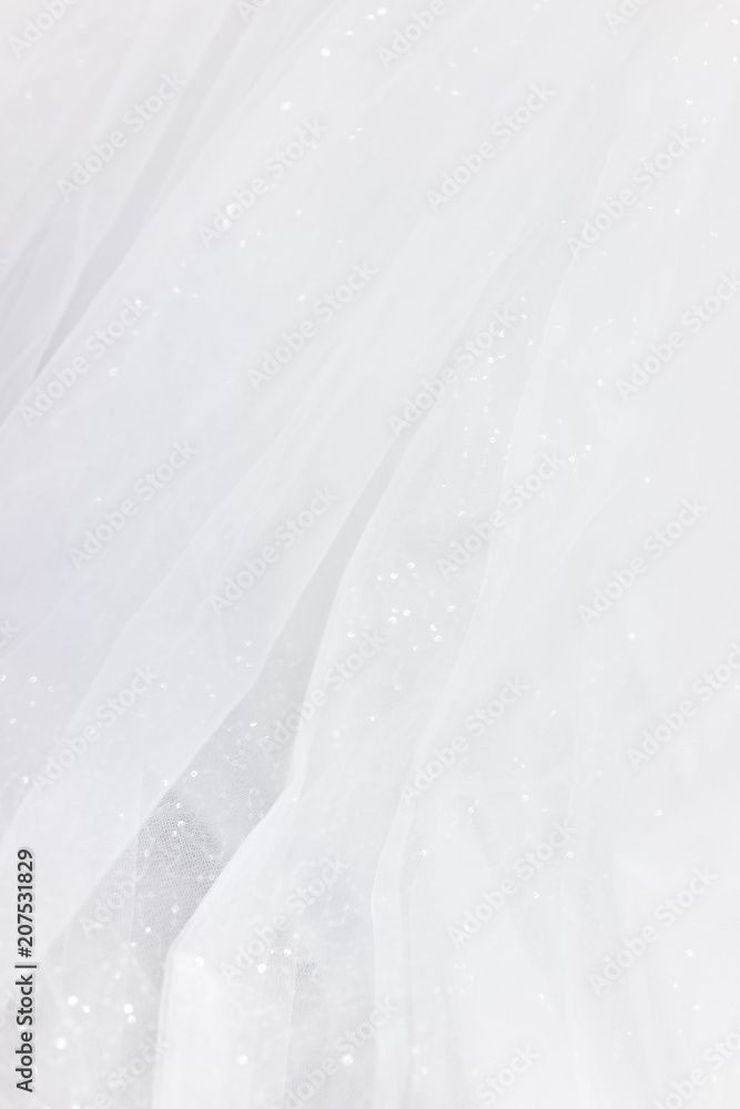 Fototapeta Macro closeup of tulle wedding dress veil material, white garment textile with shiny rhinestones design