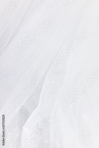 Macro closeup of tulle wedding dress veil material, white garment textile with shiny rhinestones design