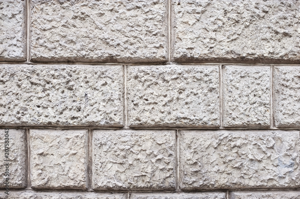 Naklejka premium Stone wall on the facade of the building - a nice stone texture